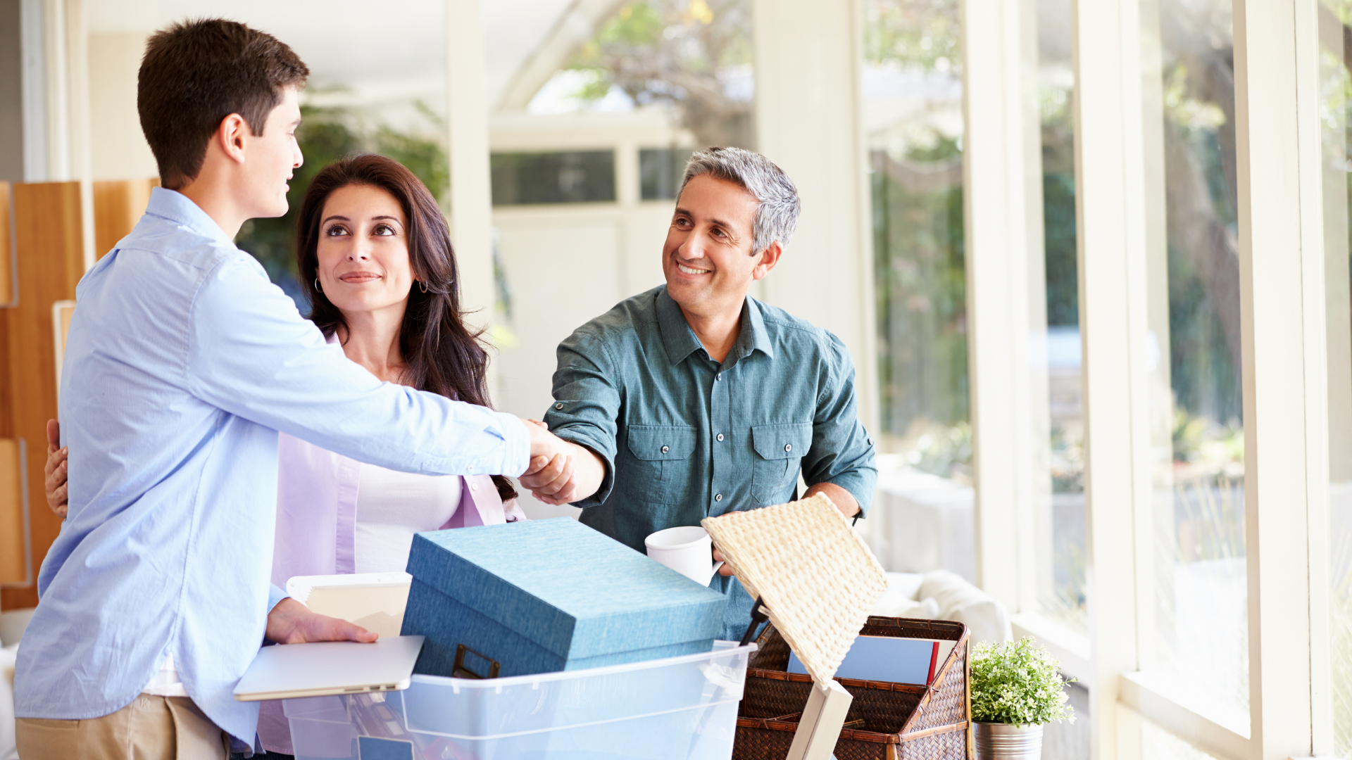 How To Prepare Your Teen For College A student and two parents are seated around a pile of boxes as they say goodbye.