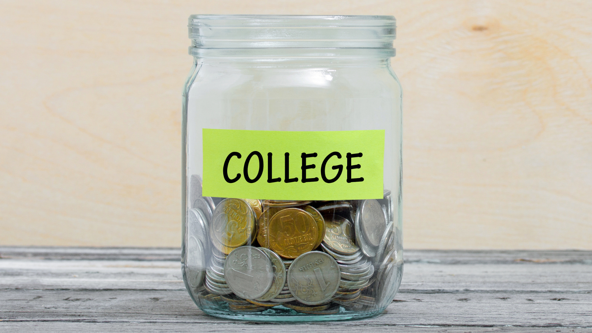 What You Need To Know About Paying For College A jar full of coins is labeled "college"