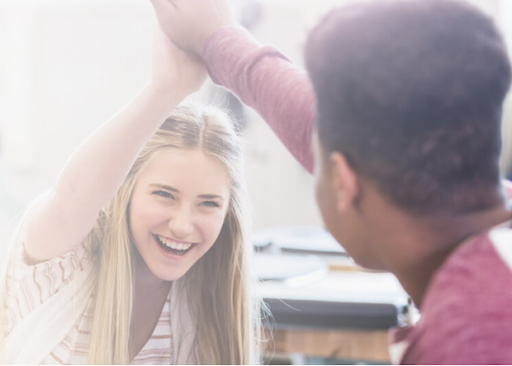 Why You Should Take Test Prep Seriously Two students, a boy and a girl, high five.